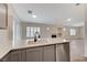 Modern kitchen with gray cabinets, stainless steel appliances, and island at 3708 Penny Cross Dr, North Las Vegas, NV 89032