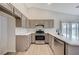 Modern kitchen with gray cabinets and stainless steel appliances at 3708 Penny Cross Dr, North Las Vegas, NV 89032