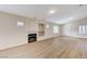 Bright living room featuring a fireplace, built-in shelving, wood floors, and natural light from multiple windows at 3708 Penny Cross Dr, North Las Vegas, NV 89032