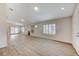 Bright living room with wood floors, modern fireplace, and large windows with plantation shutters at 3708 Penny Cross Dr, North Las Vegas, NV 89032