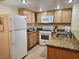 Bright kitchen features granite countertops and white appliances at 3800 Desert Marina Dr # 160, Laughlin, NV 89029