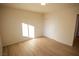 Bright bedroom with light wood floors and double door closet at 3880 Leonard St, Pahrump, NV 89060