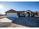 Newly constructed home with a two-car garage and neutral color scheme at 3880 Leonard St, Pahrump, NV 89060