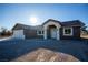 Newly built home with light-colored garage and inviting front entrance at 3880 Leonard St, Pahrump, NV 89060