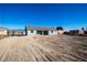 Large, unlandscaped backyard with dirt and tire tracks at 3960 Dart Dr, Pahrump, NV 89060