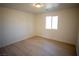 Bright bedroom with light wood laminate flooring and a window at 3960 Dart Dr, Pahrump, NV 89060