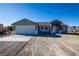 New single-story home with attached garage and neutral color scheme at 3960 Dart Dr, Pahrump, NV 89060