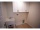 Bright laundry room with cabinets and utility sink at 3960 Dart Dr, Pahrump, NV 89060