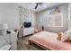 Charming bedroom with pink bedding, built-in shelving, and a desk at 4182 Bottiglia Ave, Las Vegas, NV 89141