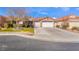 Single-story home with a two-car garage and landscaped front yard at 4182 Bottiglia Ave, Las Vegas, NV 89141