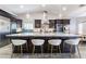 Large kitchen island with seating, granite countertop, and modern pendant lighting at 4182 Bottiglia Ave, Las Vegas, NV 89141