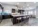 Modern kitchen boasting a large island, granite countertops, and dark wood cabinetry at 4182 Bottiglia Ave, Las Vegas, NV 89141