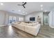 Spacious living room featuring a large sectional sofa and wood-look tile floors at 4182 Bottiglia Ave, Las Vegas, NV 89141