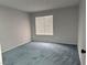 Clean and well-lit bedroom with neutral walls, carpet, and a large window at 4707 Nara Vista Way # 104, Las Vegas, NV 89103