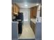 Cozy kitchen features wood cabinets, a black stove, and a bright window at 4707 Nara Vista Way # 104, Las Vegas, NV 89103