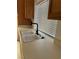 A close-up of the double sink and counter with modern faucet near a window with blinds at 4707 Nara Vista Way # 104, Las Vegas, NV 89103