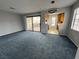 Spacious living room with sliding glass doors leading to the outside and an open view of the kitchen at 4707 Nara Vista Way # 104, Las Vegas, NV 89103