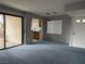 Open-concept living space with a sliding glass door, window, and view of the kitchen at 4707 Nara Vista Way # 104, Las Vegas, NV 89103