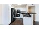 Modern kitchen featuring black appliances and granite countertops at 4955 Lindell Rd # 119, Las Vegas, NV 89118