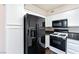 Kitchen with black appliances and white cabinets at 4955 Lindell Rd # 119, Las Vegas, NV 89118