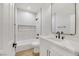 Clean bathroom with white vanity, black matte fixtures, and bathtub at 517 Annet St, Henderson, NV 89052