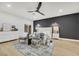 Modern primary bedroom with a plush bed and accent chairs, featuring a dark-grey accent wall at 517 Annet St, Henderson, NV 89052