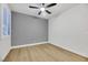 Bedroom with ceiling fan, window with shutters, and gray accent wall at 517 Annet St, Henderson, NV 89052