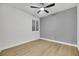 Bedroom with ceiling fan, window with shutters, and gray accent wall at 517 Annet St, Henderson, NV 89052