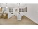 Modern dining area with white chairs and a marble table, situated next to the kitchen at 517 Annet St, Henderson, NV 89052