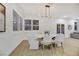 Elegant dining room with a white table and chairs, and large windows with plantation shutters at 517 Annet St, Henderson, NV 89052