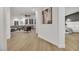 Light-filled hallway with luxury vinyl plank flooring, offering views of the living room and primary bedroom at 517 Annet St, Henderson, NV 89052