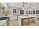 Open concept kitchen with large island, white cabinets, and wood accents at 517 Annet St, Henderson, NV 89052