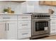 Modern kitchen with stainless steel range and white shaker cabinets at 517 Annet St, Henderson, NV 89052