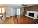 Living room with hardwood floors, fireplace, and patio doors at 5508 Big Sky, Las Vegas, NV 89149