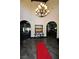 Elegant lobby with a grand chandelier and red carpet at 5508 Big Sky, Las Vegas, NV 89149