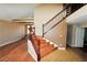 Wood staircase with a wooden railing in a light-colored room at 5508 Big Sky, Las Vegas, NV 89149