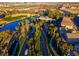 Stunning aerial view showcases lush landscaping, golf course, and water features in this exceptional community at 553 Sinfold Park St, Las Vegas, NV 89148