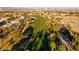 An aerial view of a lush golf course winding through a residential community with mountain views at 553 Sinfold Park St, Las Vegas, NV 89148