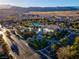 A stunning aerial shot of a community pool and recreation center surrounded by lush landscaping and desert views at 553 Sinfold Park St, Las Vegas, NV 89148