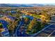 Beautiful aerial view of a luxurious community featuring a golf course, scenic water features, and well-maintained landscaping at 553 Sinfold Park St, Las Vegas, NV 89148