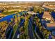 Beautiful aerial view of a community entrance featuring lush landscaping, golf course and serene water features at 553 Sinfold Park St, Las Vegas, NV 89148