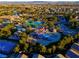 An aerial view showcasing a community water park, featuring a pool, water slides, and lush landscaping at 553 Sinfold Park St, Las Vegas, NV 89148