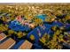 Aerial view of a neighborhood park with a playground and beach volleyball court surrounded by mature trees at 553 Sinfold Park St, Las Vegas, NV 89148