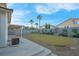 Spacious backyard with desert landscaping, a covered patio, and a view of the surrounding homes at 553 Sinfold Park St, Las Vegas, NV 89148