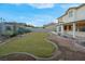 Spacious backyard boasting a lush lawn, stone accents, and a covered patio for relaxation at 553 Sinfold Park St, Las Vegas, NV 89148