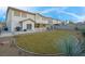 Beautiful backyard featuring a lush lawn and covered patio, perfect for outdoor entertaining at 553 Sinfold Park St, Las Vegas, NV 89148