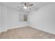 Bright, neutral bedroom features a ceiling fan, window with blinds, and plush carpet at 553 Sinfold Park St, Las Vegas, NV 89148