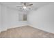 Bright bedroom featuring neutral carpet, ceiling fan, and a window with blinds at 553 Sinfold Park St, Las Vegas, NV 89148