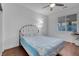 Cozy bedroom with a light blue comforter, ceiling fan, and wood flooring at 553 Sinfold Park St, Las Vegas, NV 89148