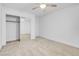 Carpeted bedroom showcasing a closet with mirrored sliding doors and a ceiling fan at 553 Sinfold Park St, Las Vegas, NV 89148